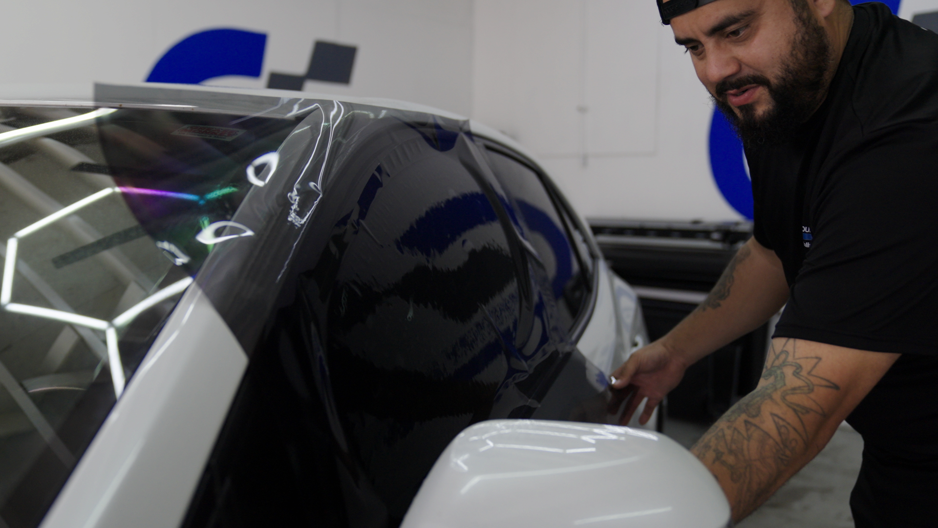 Professional installer applying automotive window tint to a vehicle in Corpus Christi, Texas